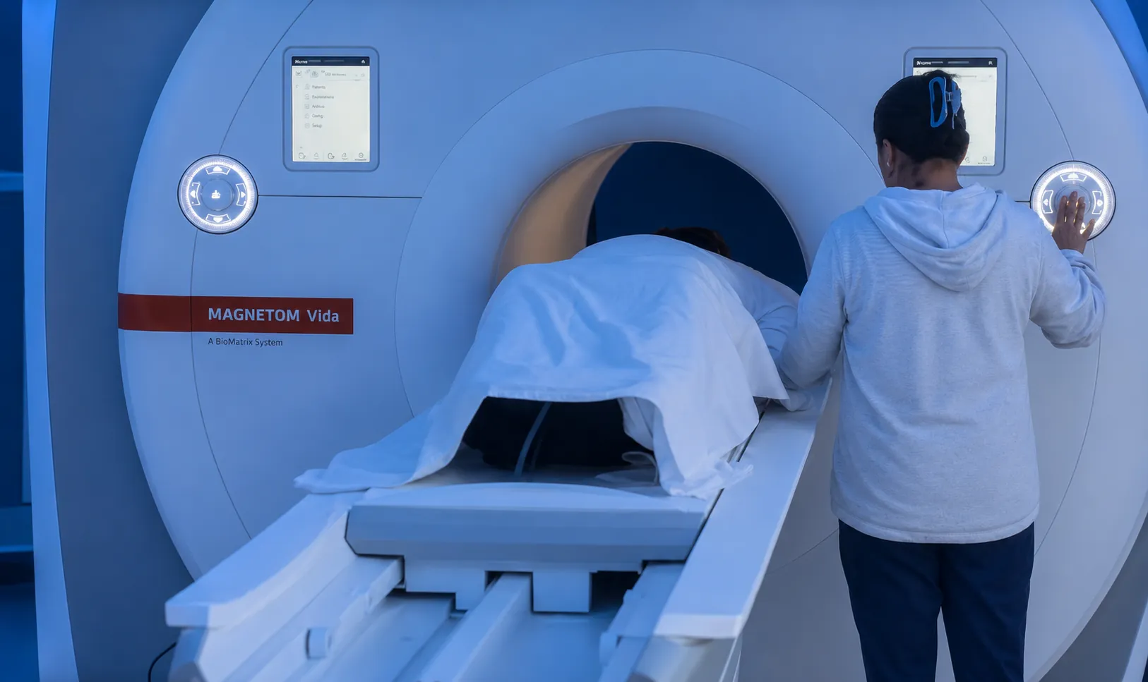 A patient entering a Siemens Magnetom Vida MRI at Hospital Angeles, technician at the console