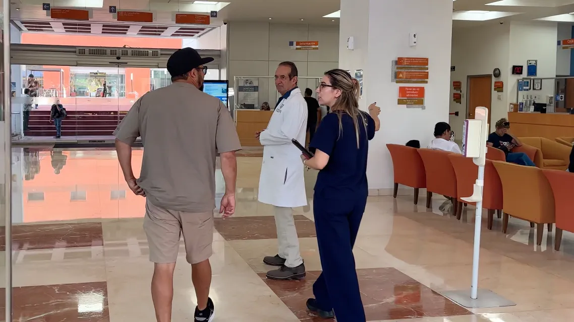Ken walking into Hospital Angeles with a physician and a nurse