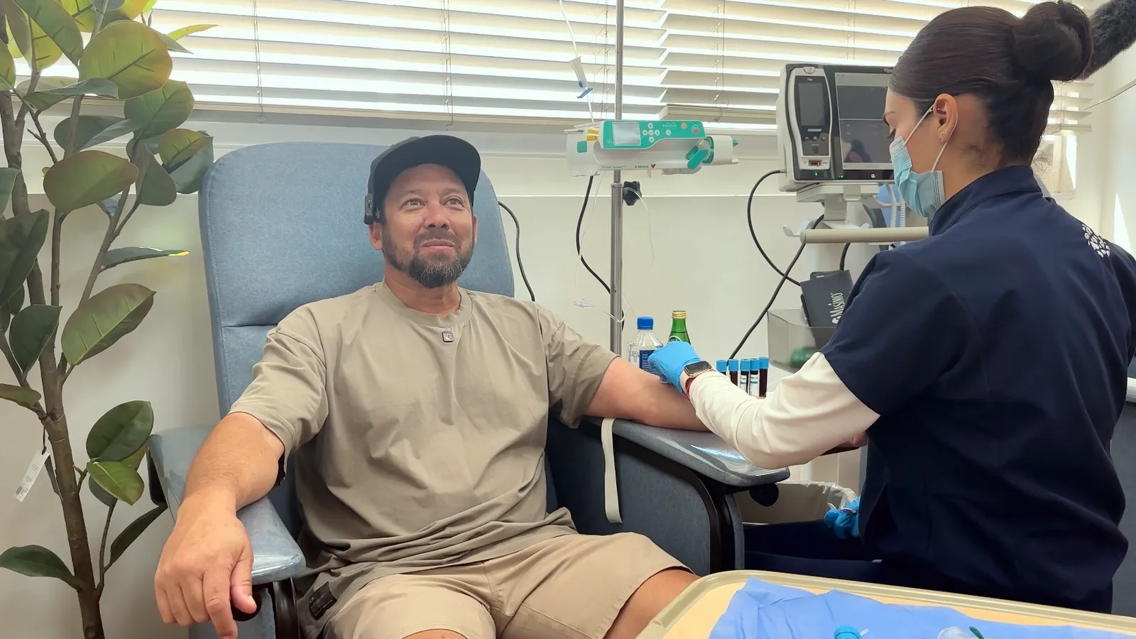 A nurse starting Ken's IV in the infusion suite