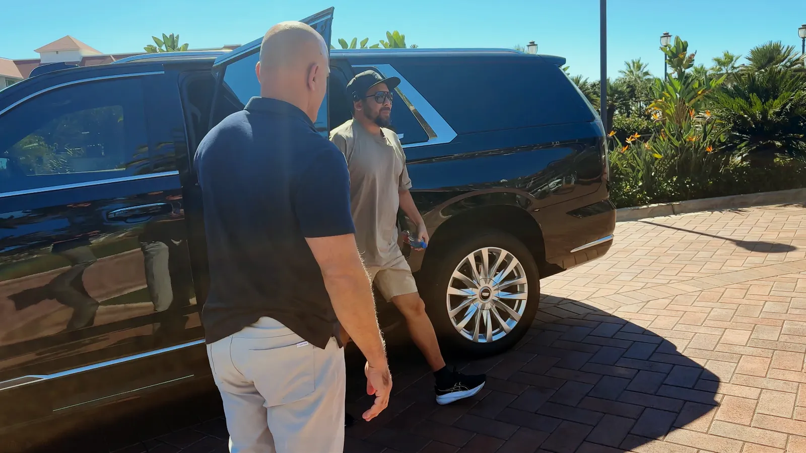 Ken getting out of the car back at the hotel