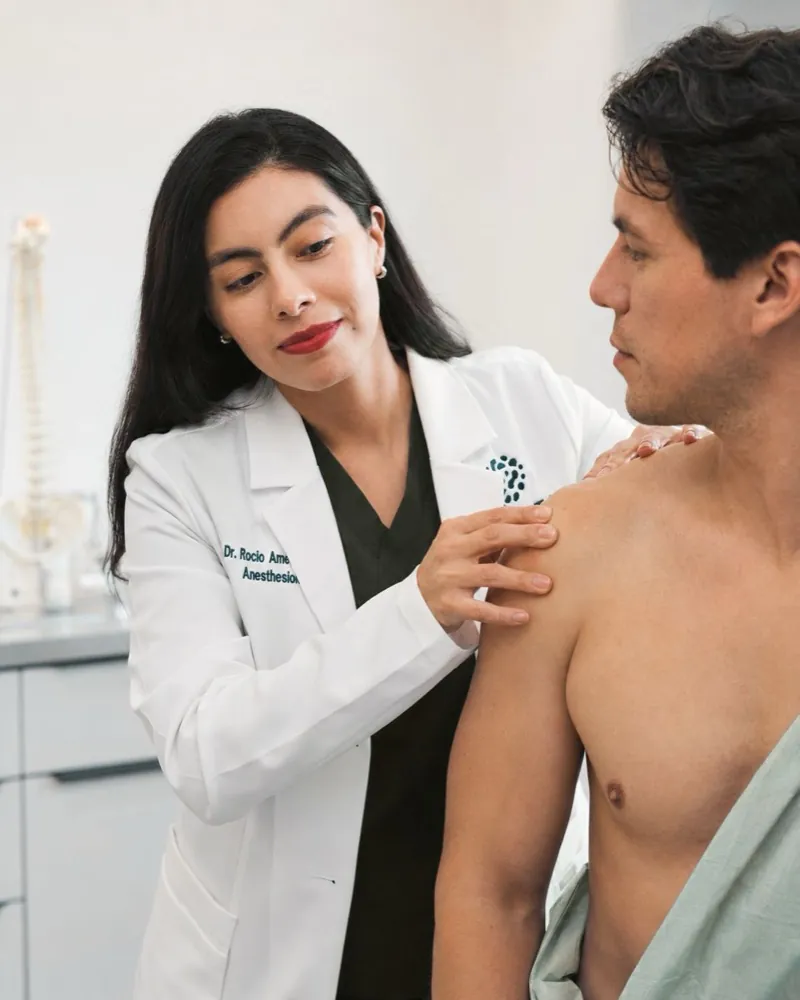Celva clinician evaluating a patient's shoulder